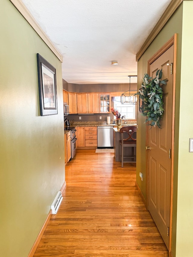 corridor featuring sink and light hardwood / wood-style flooring