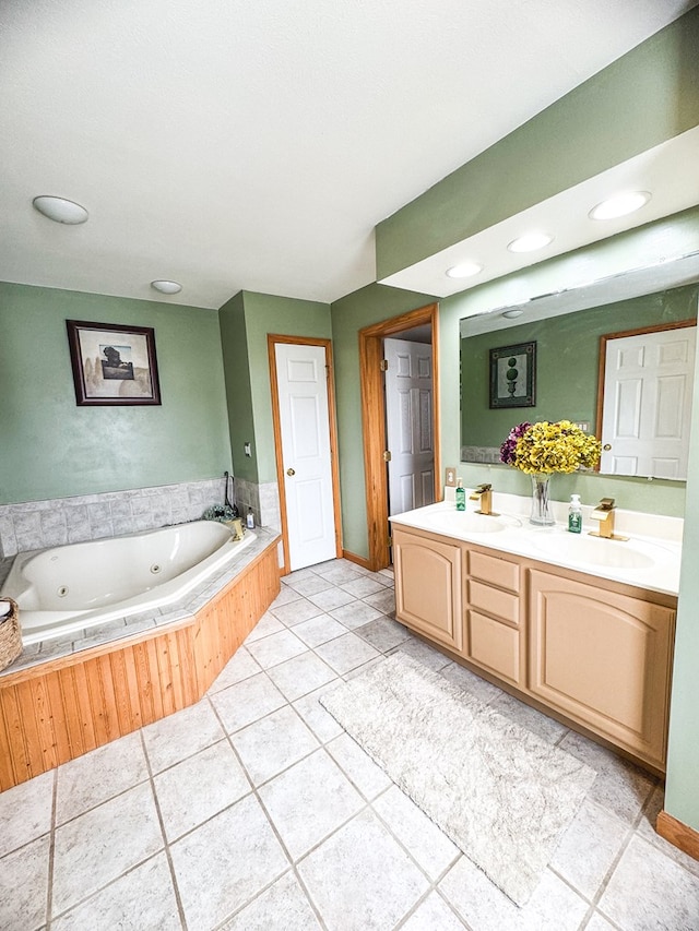 bathroom with vanity, tile patterned flooring, and tiled bath