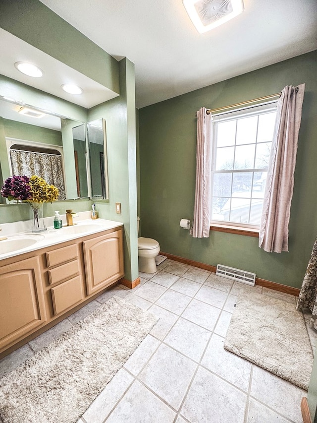 bathroom with vanity, toilet, and tile patterned flooring