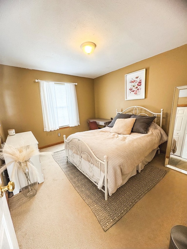 carpeted bedroom featuring a textured ceiling