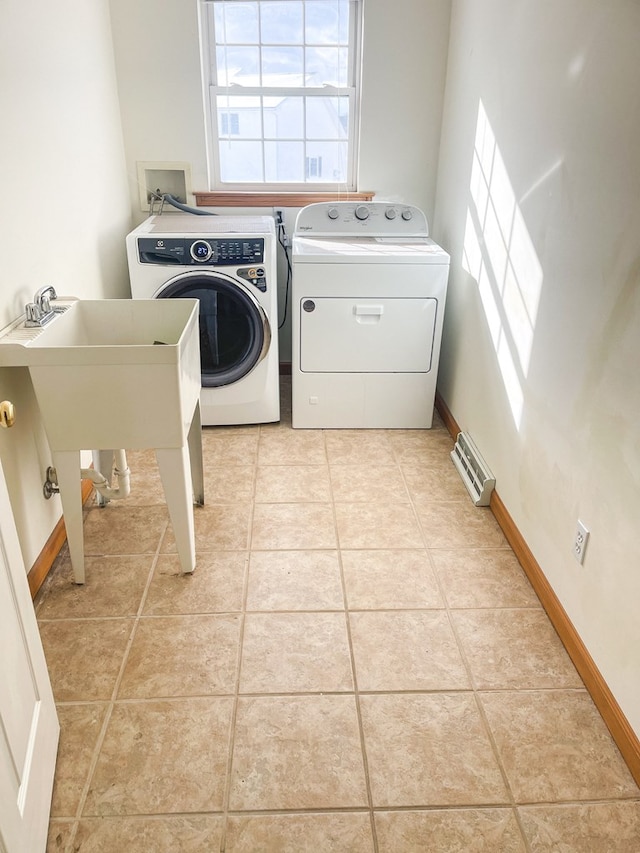 laundry room with washer and clothes dryer and light tile patterned flooring