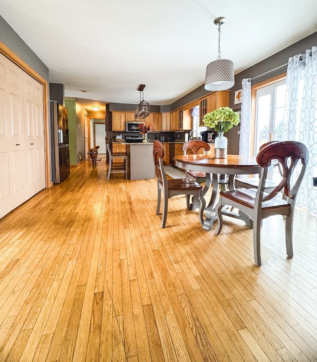 dining area featuring light wood-type flooring