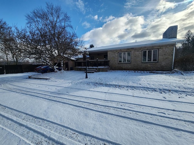 view of snow covered rear of property