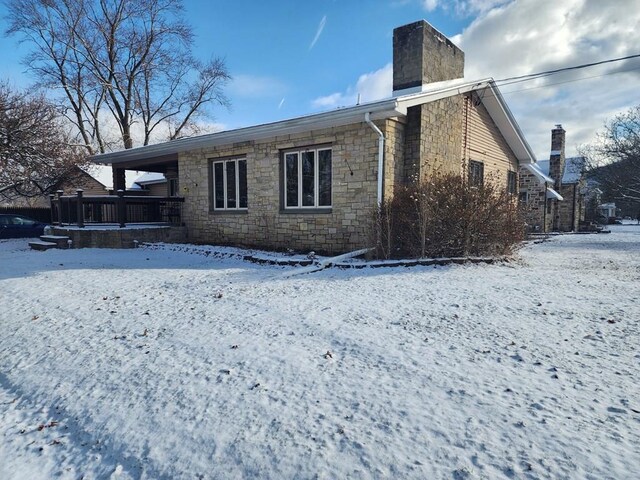 view of snow covered rear of property