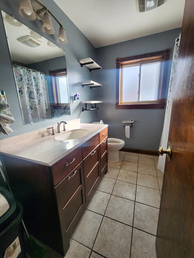 bathroom with vanity, tile patterned floors, and toilet