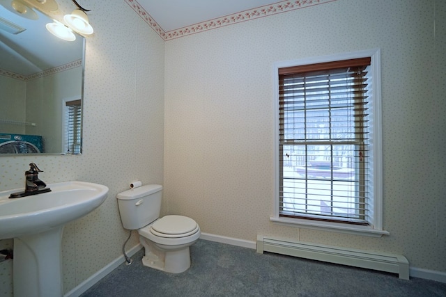 bathroom featuring sink, baseboard heating, and toilet