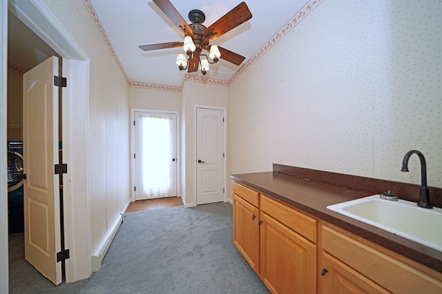 interior space with ceiling fan, sink, light colored carpet, and crown molding