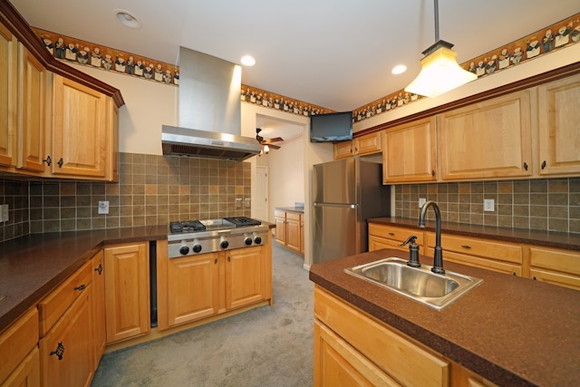 kitchen with ceiling fan, appliances with stainless steel finishes, sink, decorative backsplash, and island range hood