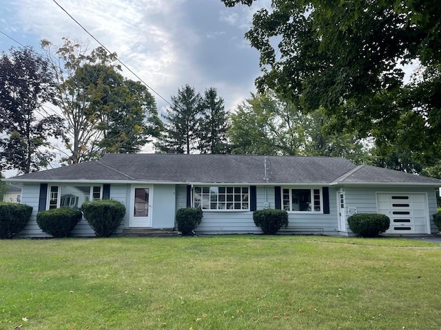 single story home featuring a garage and a front lawn