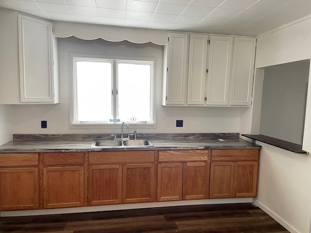 kitchen featuring sink, dark wood-type flooring, and white cabinets