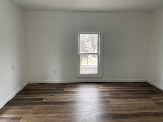 spare room with dark hardwood / wood-style flooring