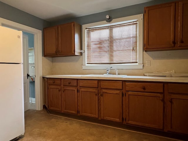 kitchen featuring sink and white fridge