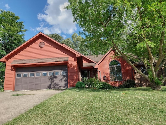 view of front of property featuring a garage and a front yard