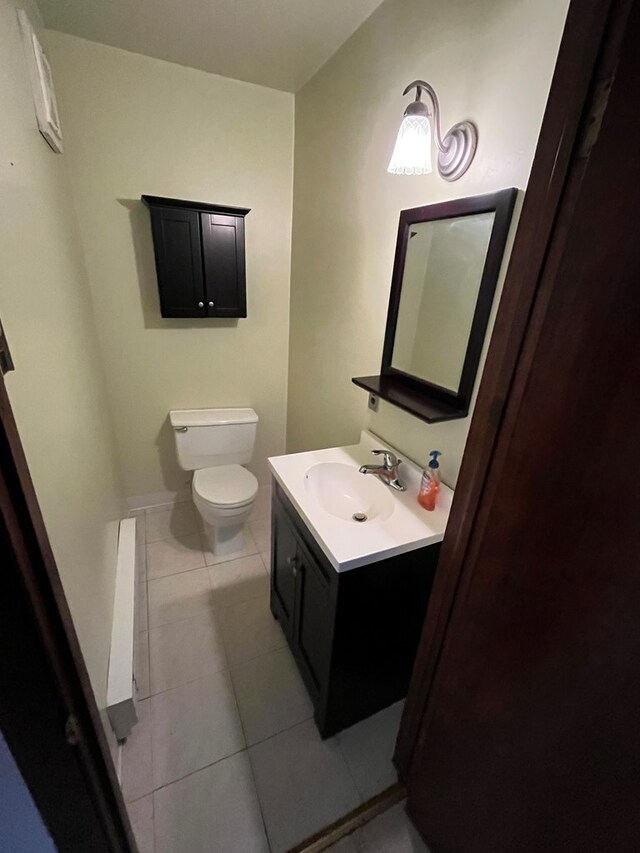 bathroom featuring vanity, tile patterned floors, and toilet