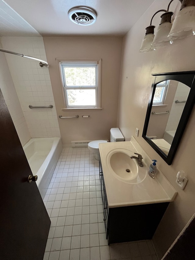 full bathroom featuring tile patterned floors, toilet, tiled shower / bath combo, and vanity