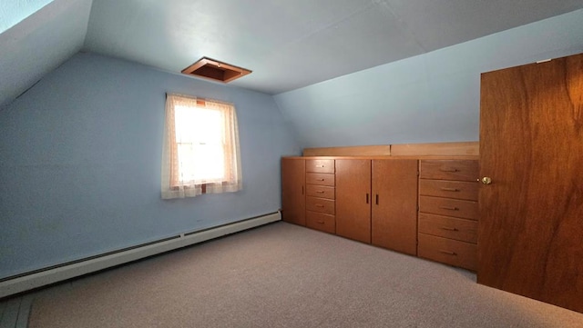 additional living space featuring baseboard heating, lofted ceiling, and light carpet