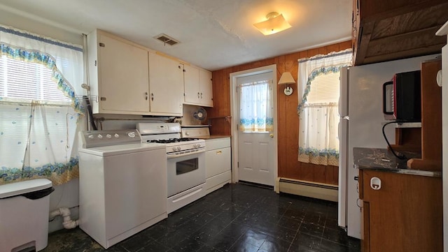 kitchen with white cabinets, washer / dryer, white range with gas stovetop, and baseboard heating