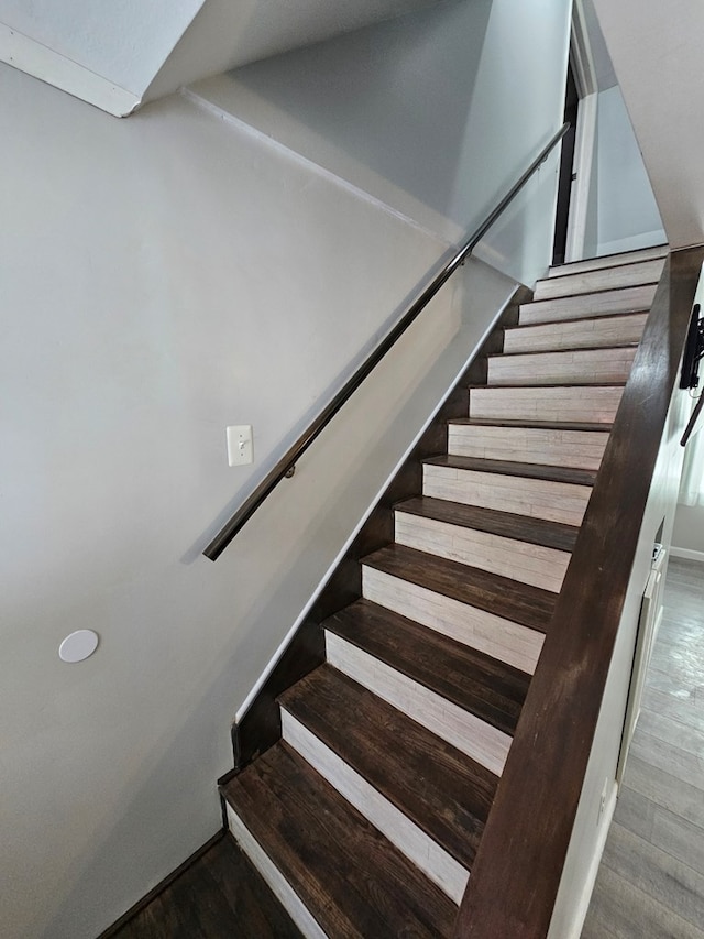 staircase featuring hardwood / wood-style flooring