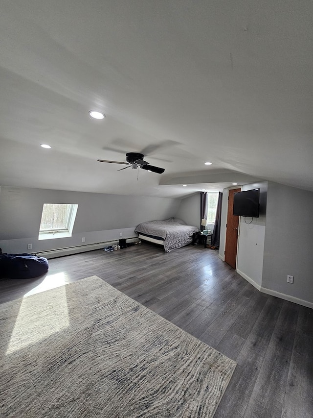 additional living space featuring vaulted ceiling, dark wood-type flooring, and a wealth of natural light