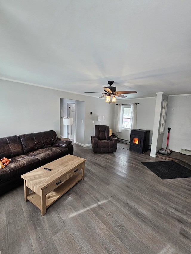 living room featuring ceiling fan, ornamental molding, dark hardwood / wood-style flooring, and a wood stove