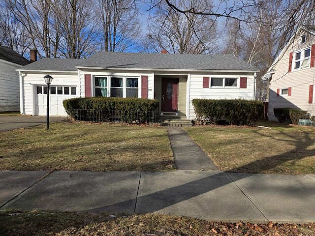 single story home featuring a garage and a front yard