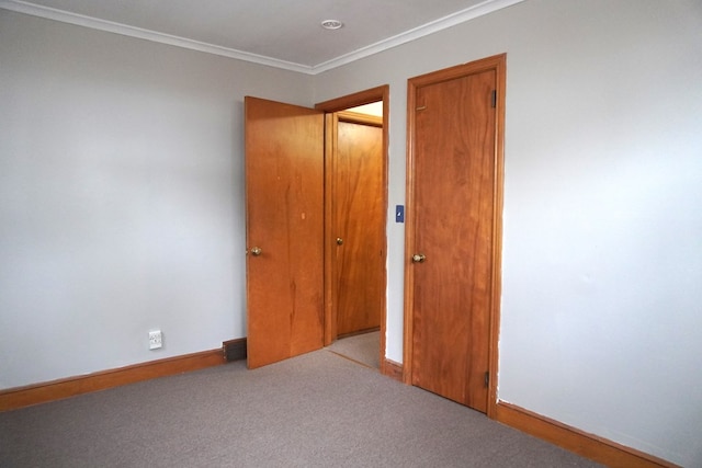 unfurnished bedroom with crown molding and light colored carpet