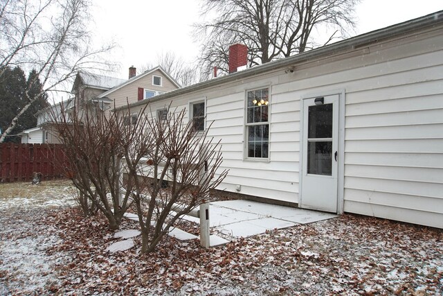 view of snow covered rear of property