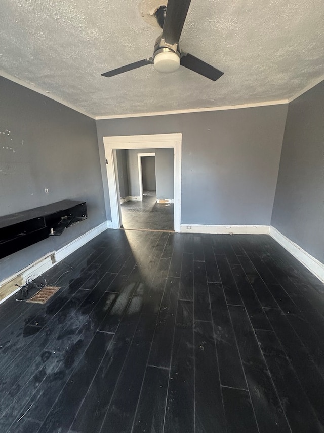 unfurnished living room with ceiling fan, dark wood-type flooring, and a textured ceiling