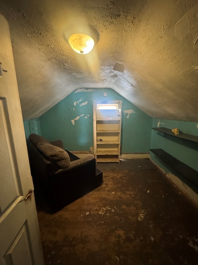 bonus room with vaulted ceiling and a textured ceiling