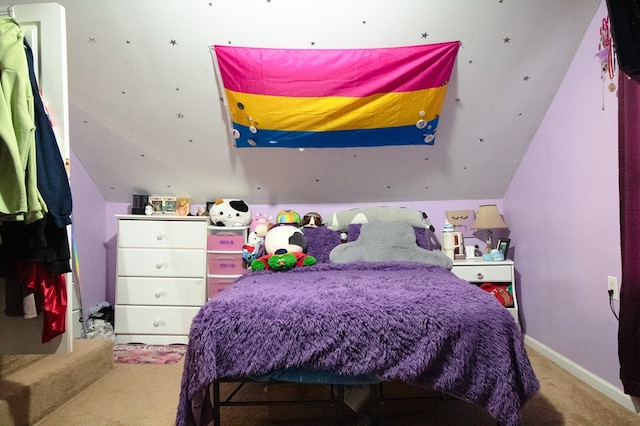 bedroom with light carpet and lofted ceiling