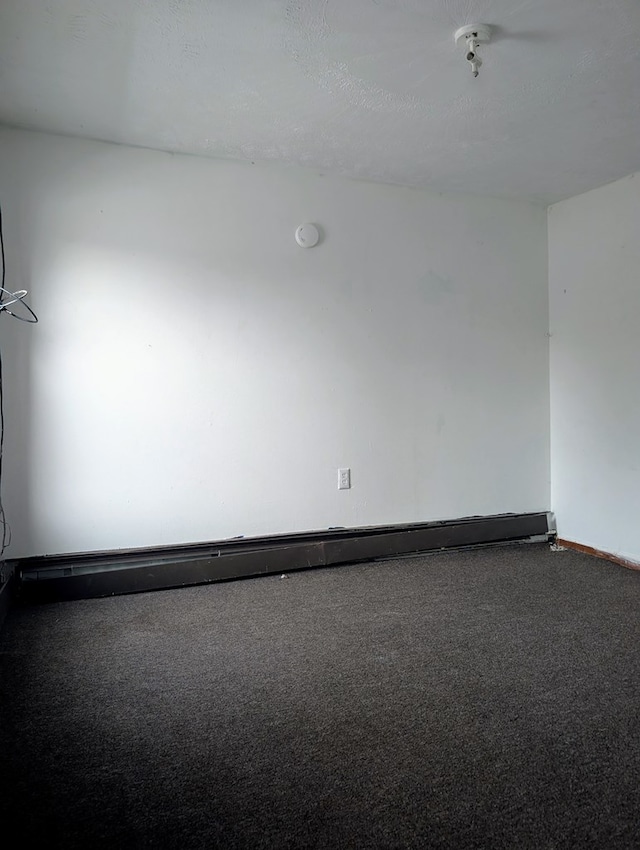 carpeted empty room with baseboard heating