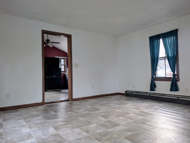 unfurnished room featuring a baseboard radiator and vaulted ceiling