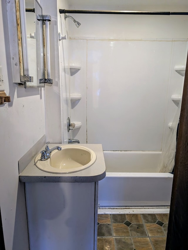 bathroom with washtub / shower combination and vanity