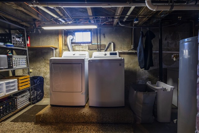 clothes washing area with water heater and independent washer and dryer