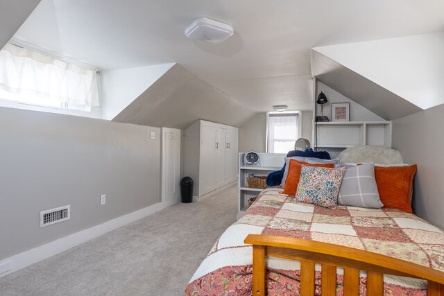 bedroom featuring vaulted ceiling and light carpet