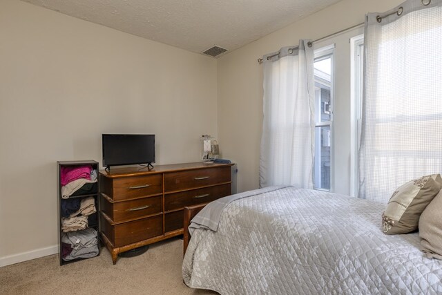 carpeted bedroom with a textured ceiling