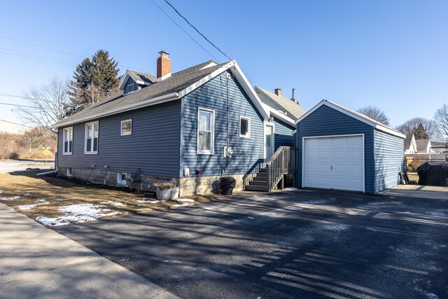 view of side of property with a garage and an outdoor structure