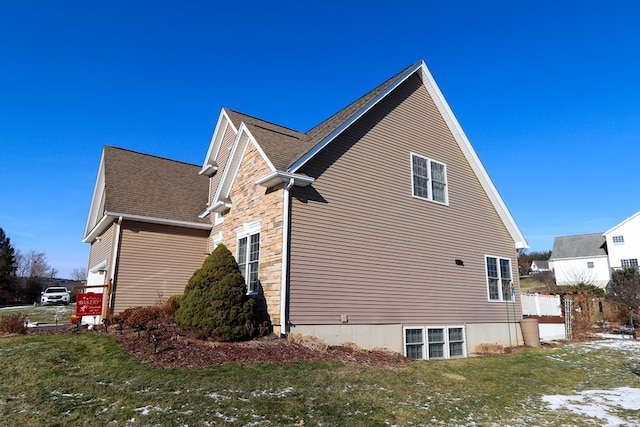 view of side of property with a yard