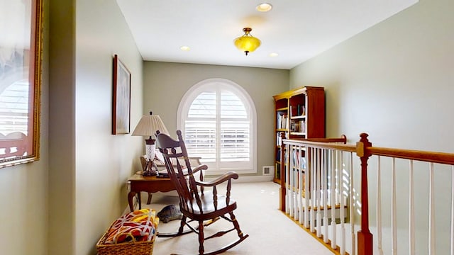 corridor featuring light colored carpet