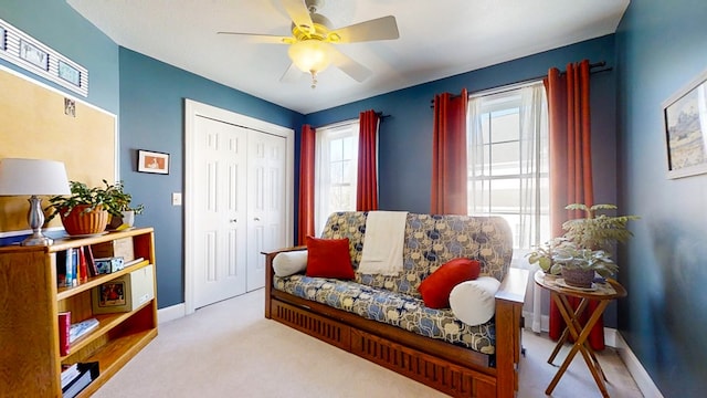 sitting room with light colored carpet and ceiling fan