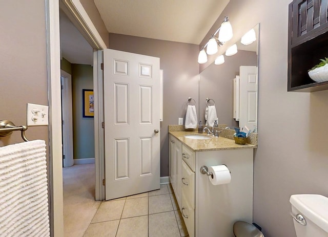 bathroom featuring vanity, toilet, and tile patterned flooring