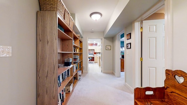 hall featuring light colored carpet