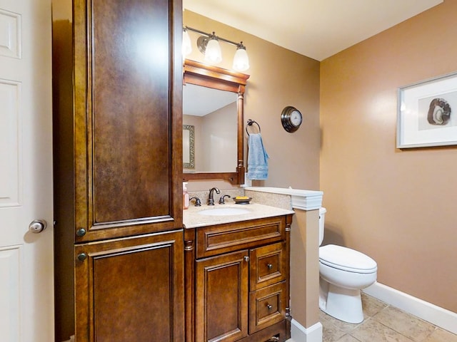 bathroom with vanity, toilet, and tile patterned flooring