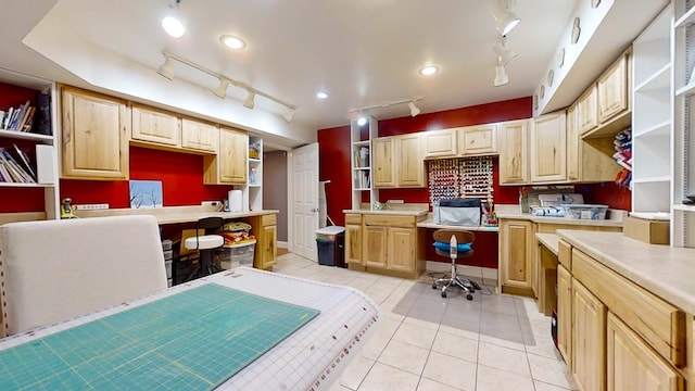 kitchen with light tile patterned floors and light brown cabinets