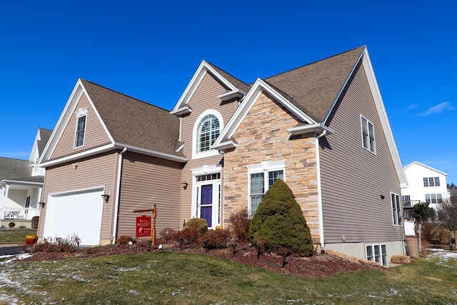 view of property featuring a garage and a front yard