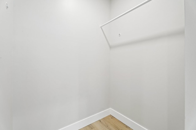 walk in closet with wood-type flooring