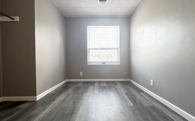 unfurnished room with dark wood-type flooring