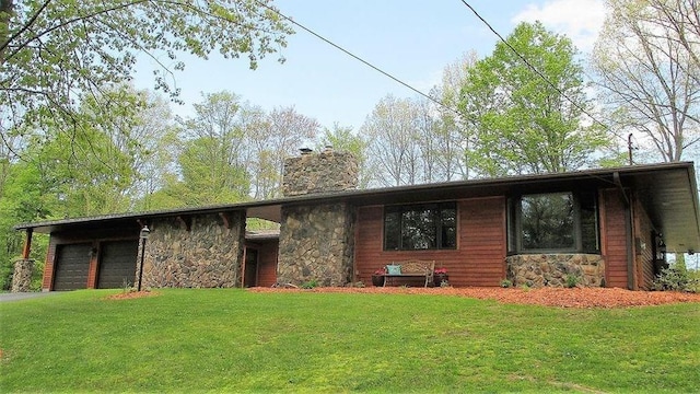 view of front facade with a garage, a front lawn, and a carport