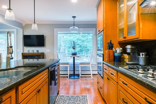 kitchen featuring sink, crown molding, stainless steel appliances, and hanging light fixtures