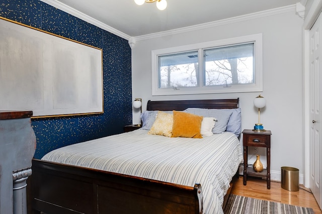 bedroom featuring crown molding, wood-type flooring, and a closet